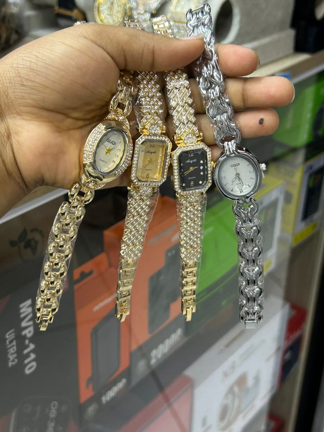 A handful of gold bracelet watches fanned out